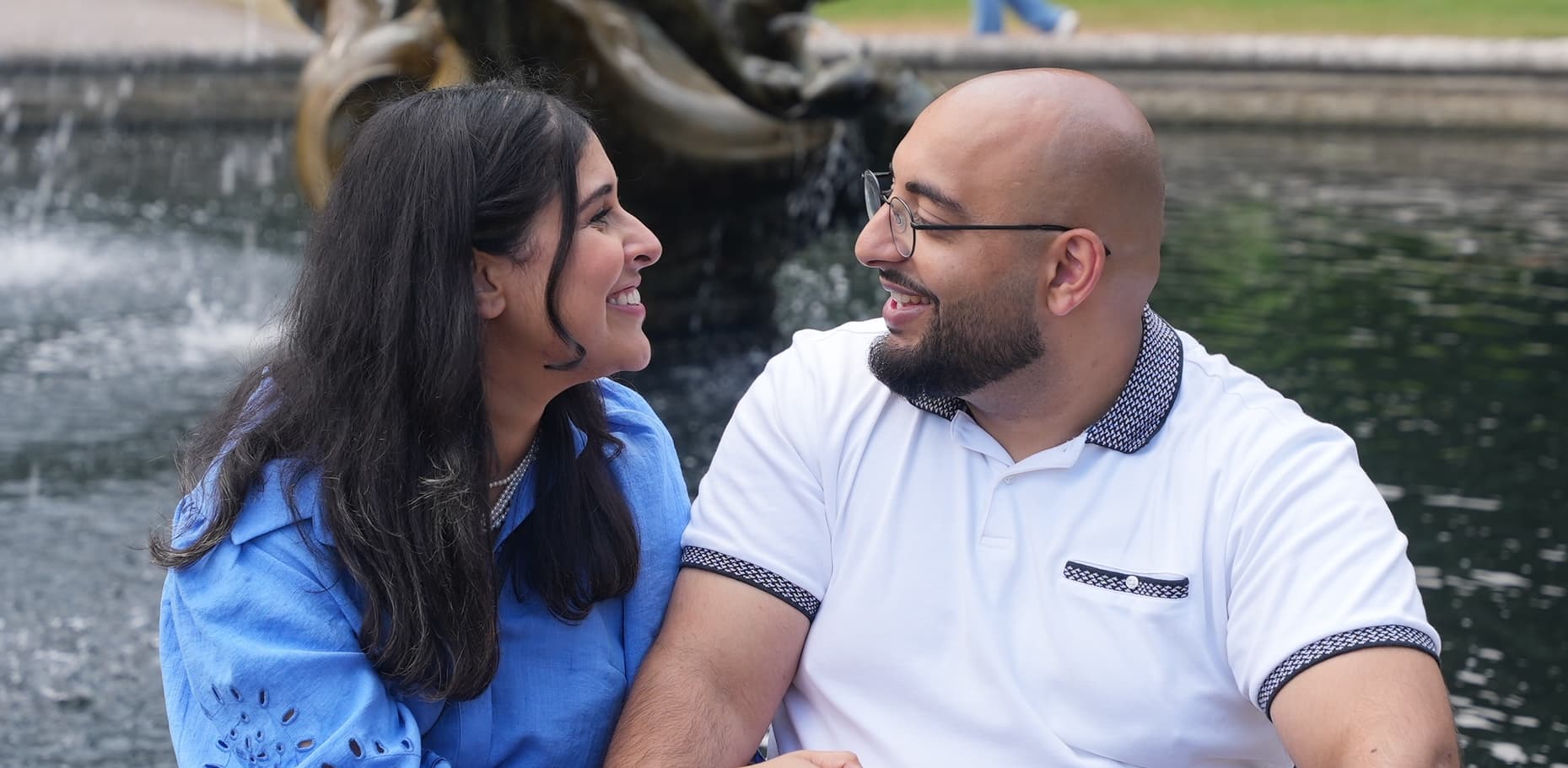 Mahdia and Farhan are sitting in front of an opulent fountain